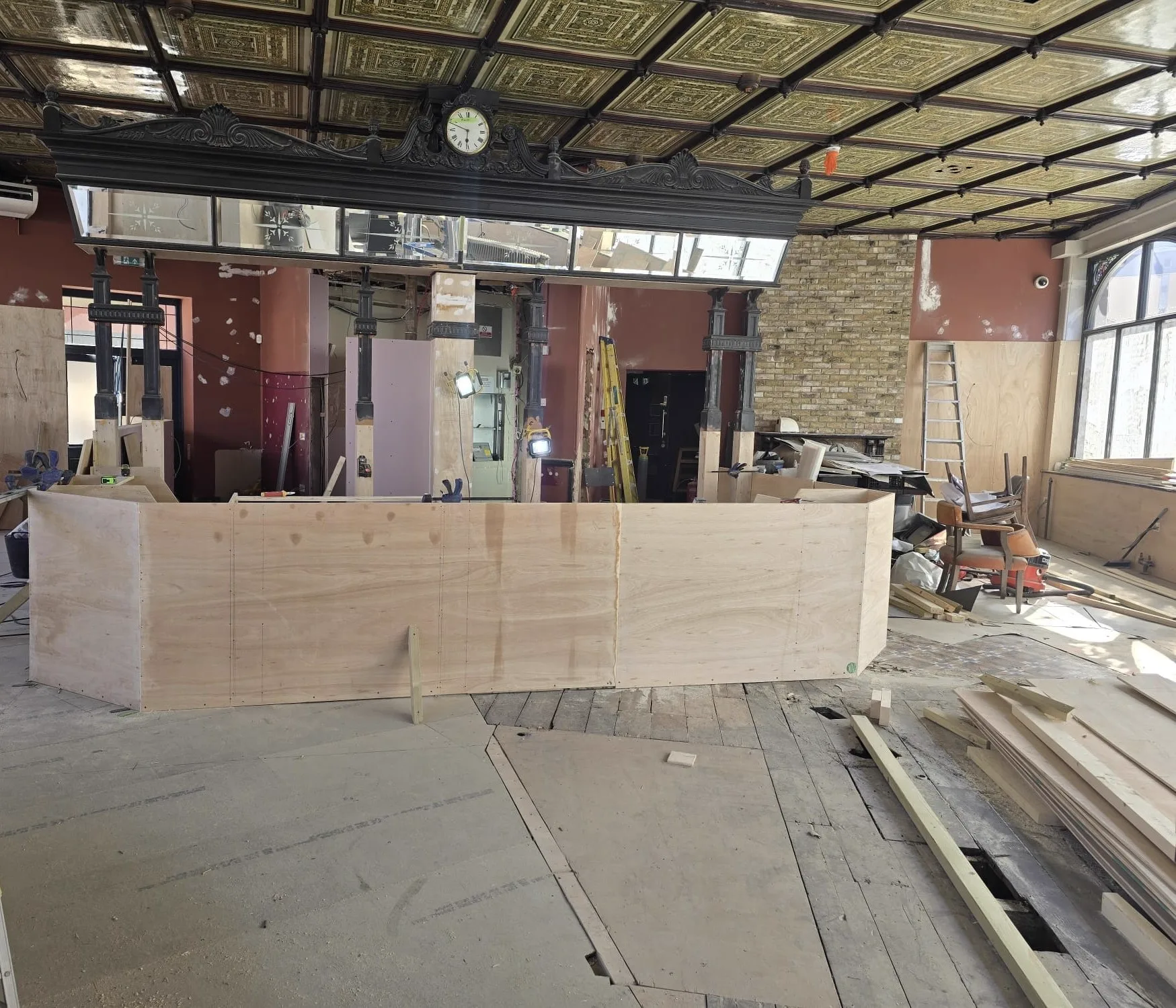New plywood bar shell taking shape beneath the original clock gantry