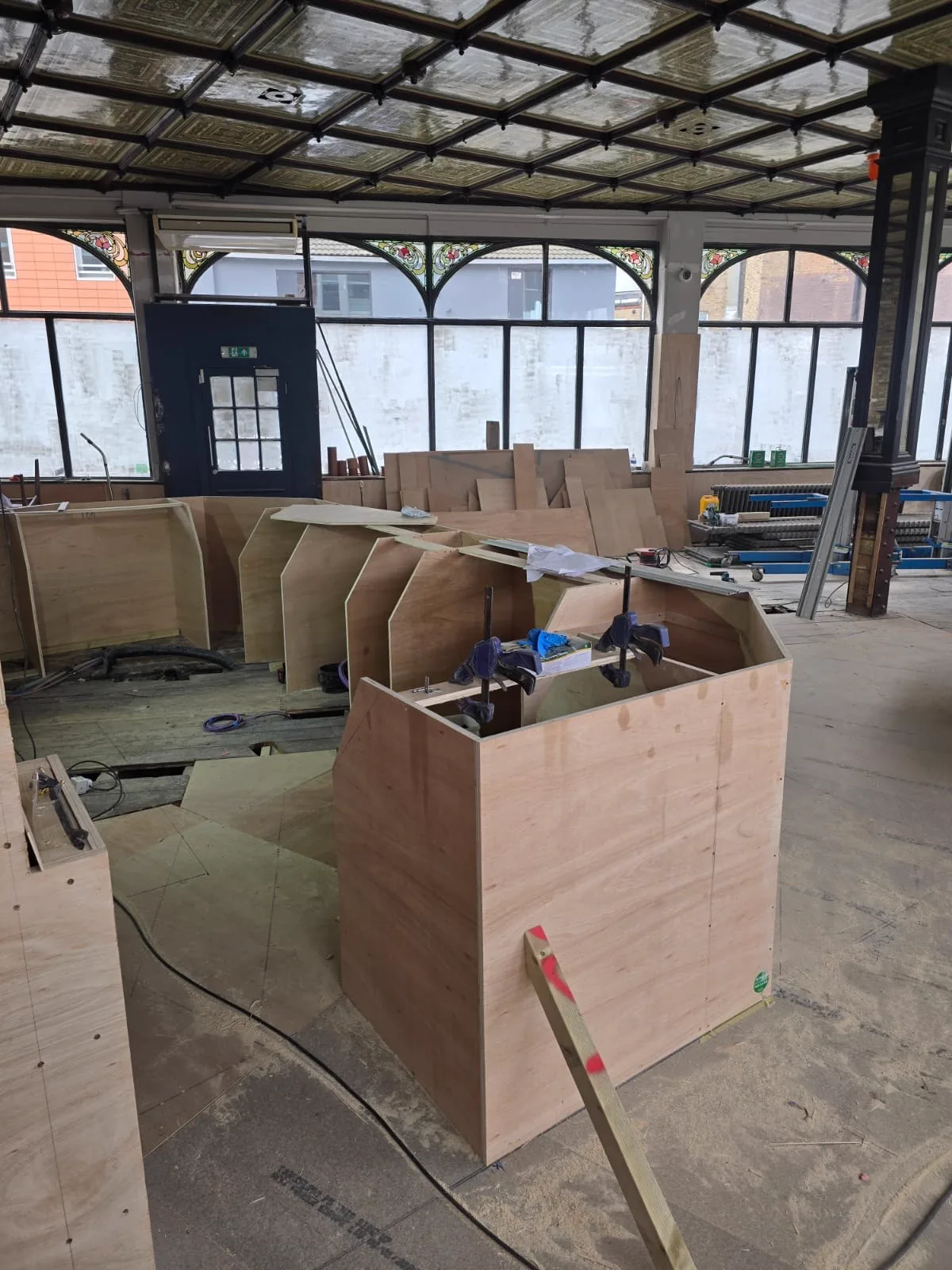 Bespoke plywood booth frames under construction inside The Fleet Tavern